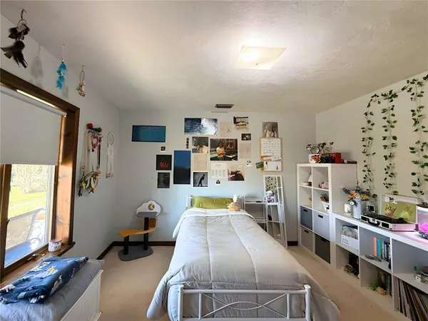 a bedroom with furniture and a book shelf