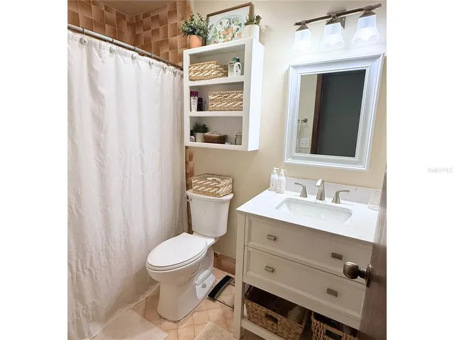 a bathroom with a toilet a sink and a mirror