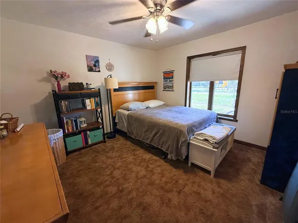 a bedroom with a bed and a large mirror