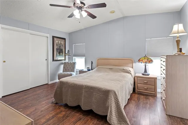 a bedroom with a bed and wooden floor