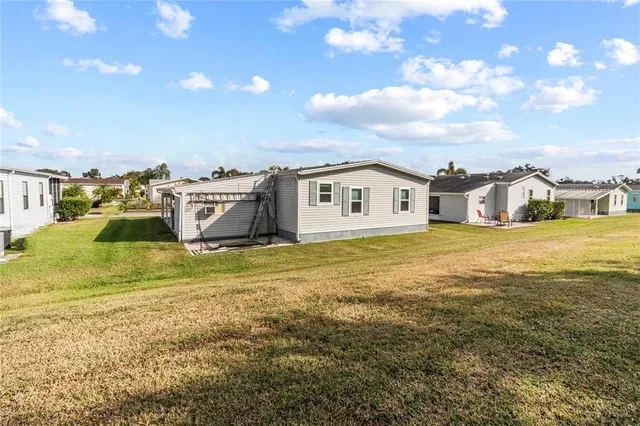 a backyard of a house with table and chairs