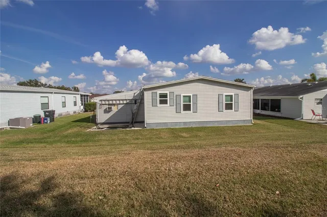 a view of a house with a backyard