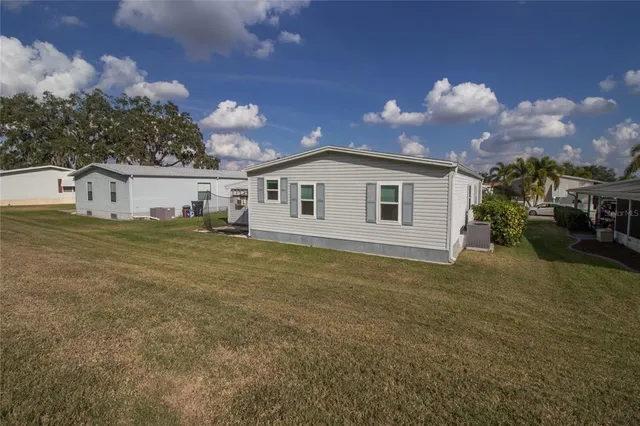 a view of a house with swimming pool and sitting area