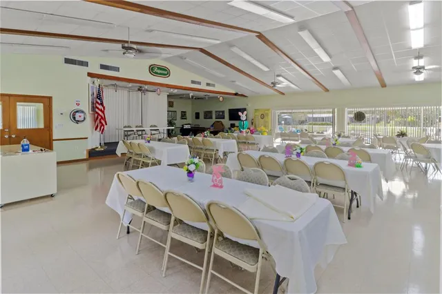 a view of a swimming pool with outdoor seating and patio