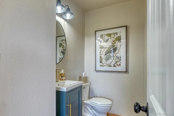 a bathroom with a toilet a sink and mirror