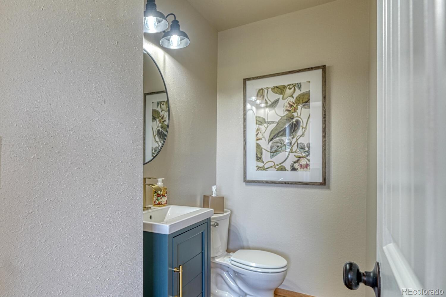 895 Acorn Road Cotopaxi, CO 81223 - Photo 15 of 50 a bathroom with a toilet a sink and mirror