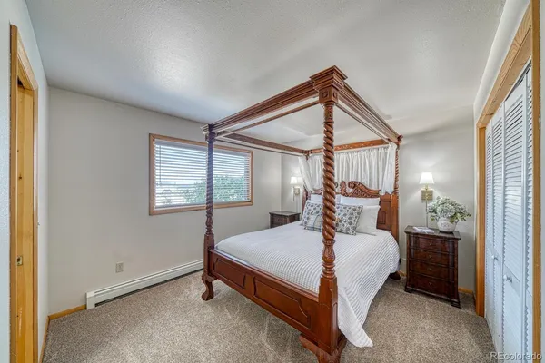 a bed room with a bed and a window