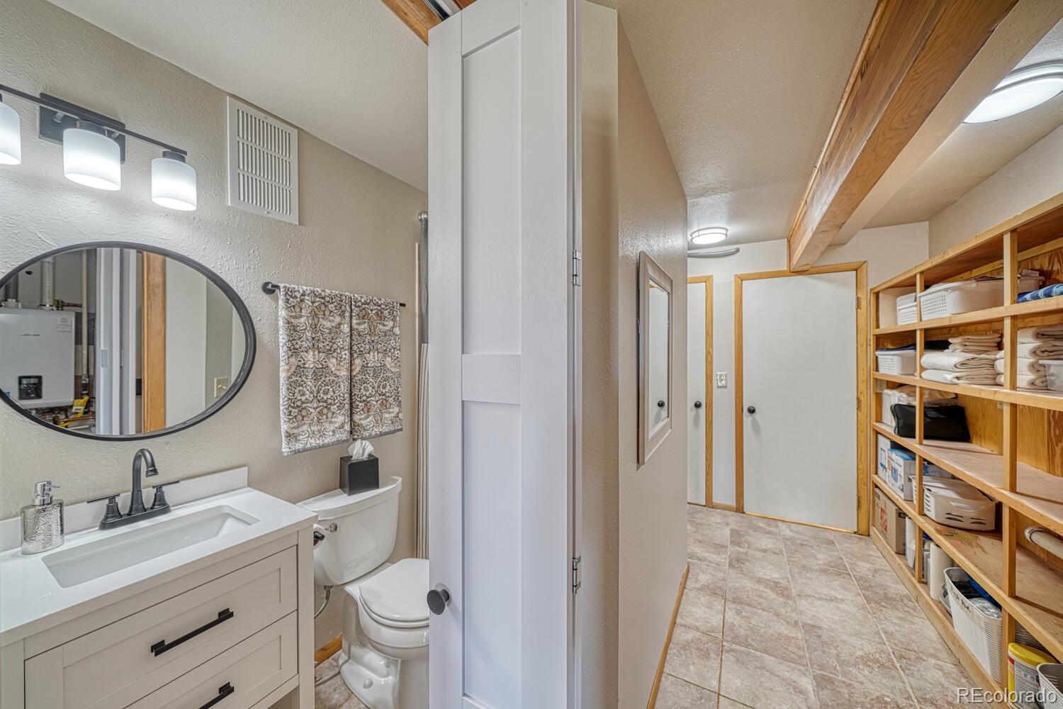 895 Acorn Road Cotopaxi, CO 81223 - Photo 27 of 50 a bathroom with a double vanity sink mirror and toilet