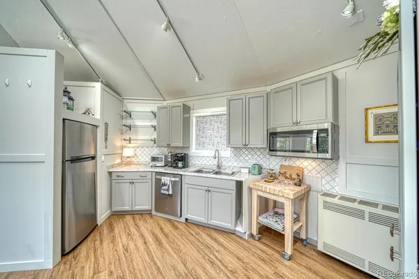 a kitchen with refrigerator and cabinets