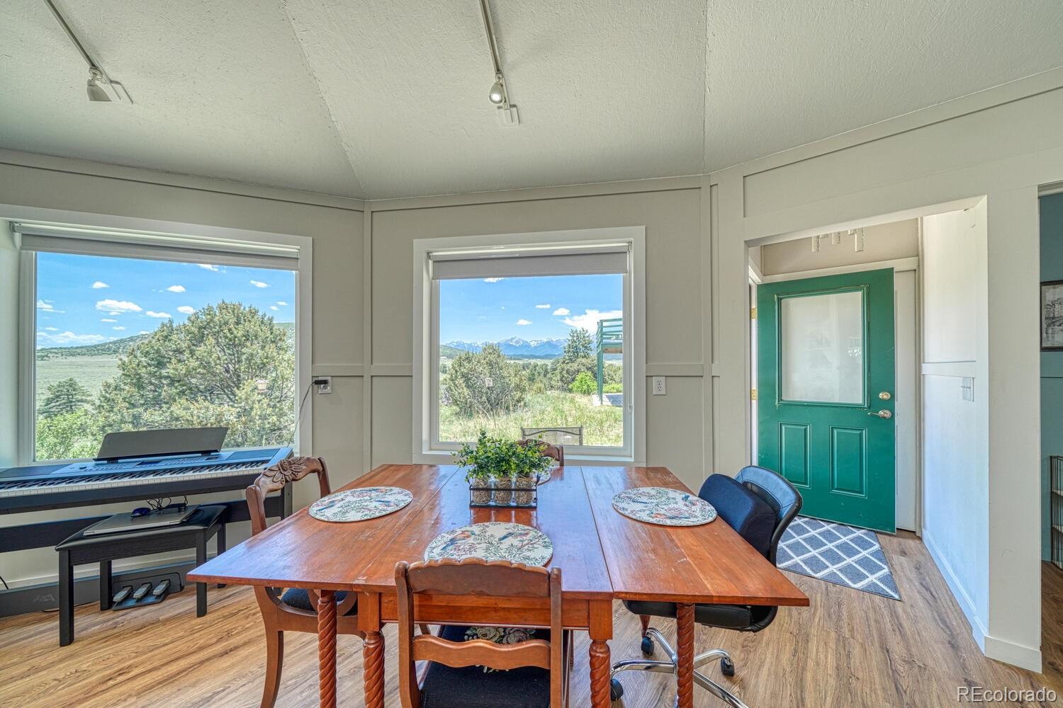 895 Acorn Road Cotopaxi, CO 81223 - Photo 44 of 50 a view of a dining room with furniture window and wooden floor