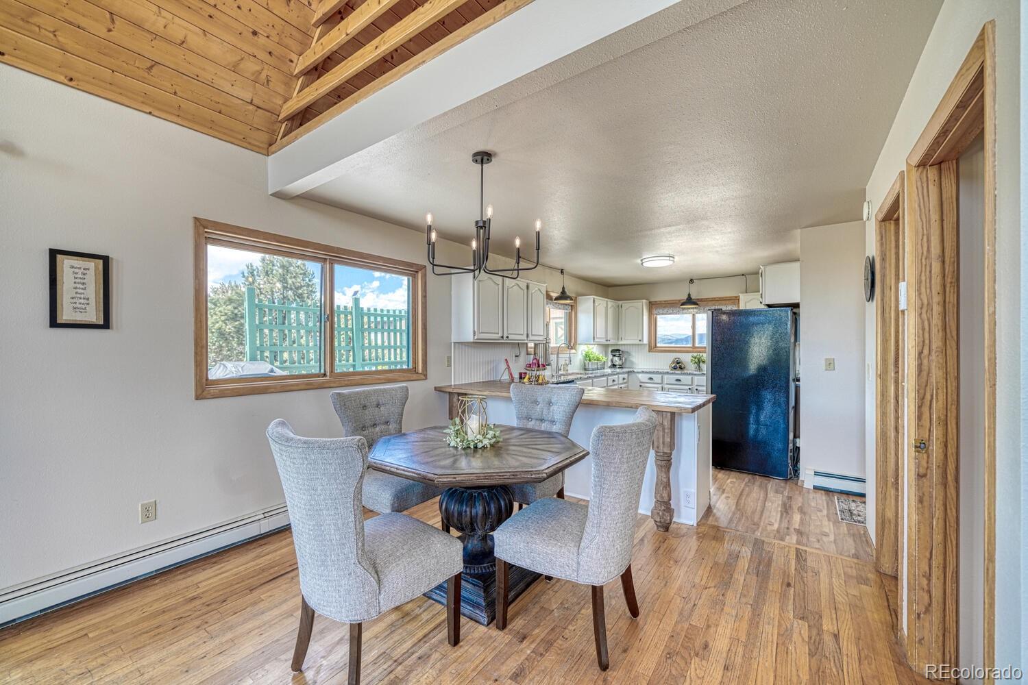 895 Acorn Road Cotopaxi, CO 81223 - Photo 9 of 50 a view of a dining room with furniture and wooden floor