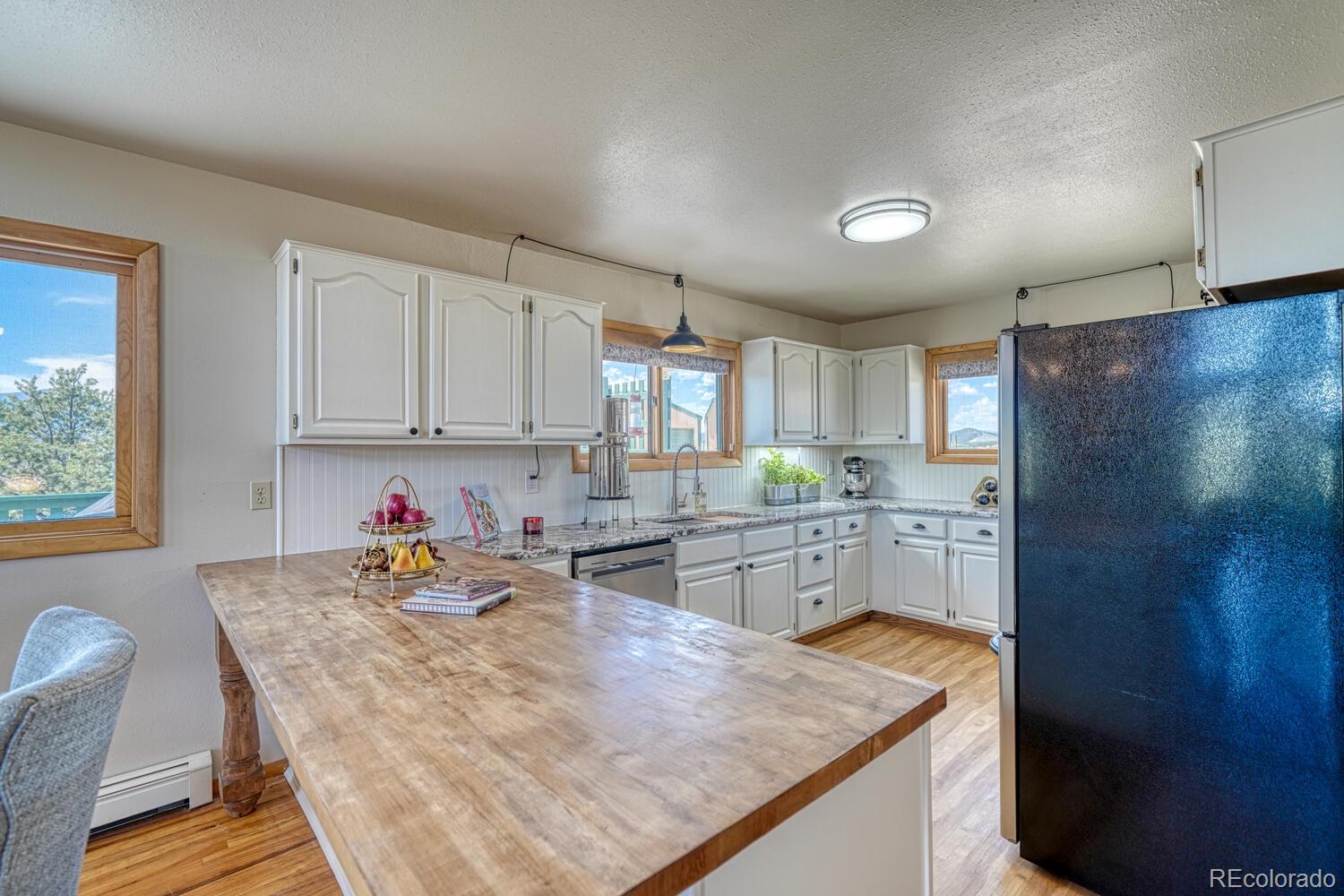 895 Acorn Road Cotopaxi, CO 81223 - Photo 10 of 50 a kitchen with stainless steel appliances granite countertop a sink refrigerator and cabinets