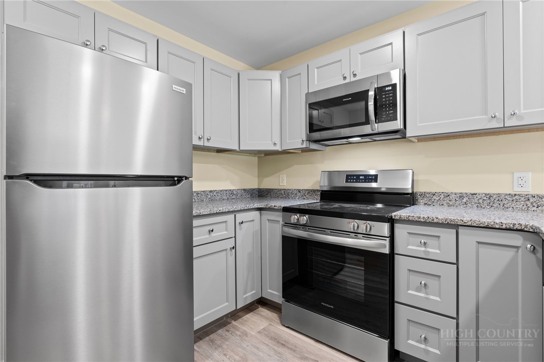 128 Zeb Street, Unit A104 Boone, NC 28607 - Photo 11 of 35 a kitchen with cabinets stainless steel appliances and a counter space