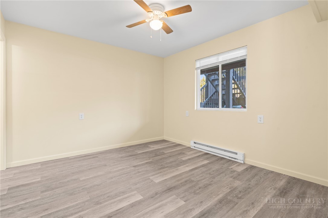 128 Zeb Street, Unit A104 Boone, NC 28607 - Photo 14 of 35 an empty room with wooden floor and windows