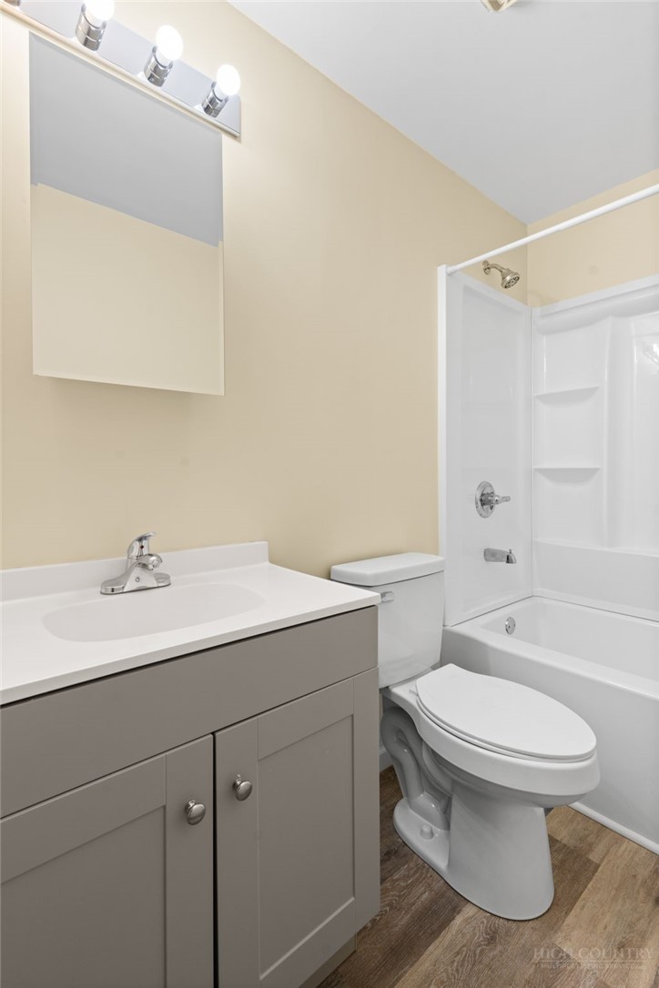128 Zeb Street, Unit A104 Boone, NC 28607 - Photo 17 of 35 a bathroom with a sink a toilet and shower