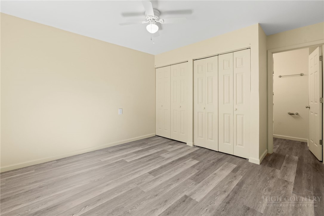 128 Zeb Street, Unit A104 Boone, NC 28607 - Photo 19 of 35 an empty room with wooden floor fan and windows