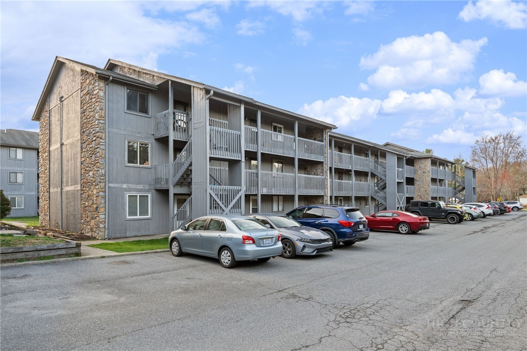 128 Zeb Street, Unit A104 Boone, NC 28607 - Photo 2 of 35 a cars parked in front of a building