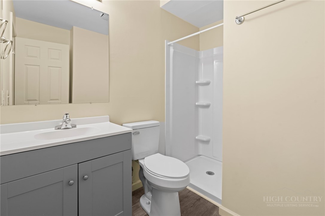 128 Zeb Street, Unit A104 Boone, NC 28607 - Photo 21 of 35 a bathroom with a toilet sink vanity and mirror