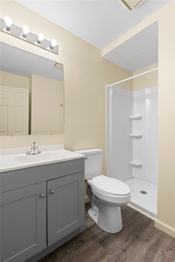 128 Zeb Street, Unit A104 Boone, NC 28607 - Photo 22 of 35 a bathroom with a toilet sink and mirror