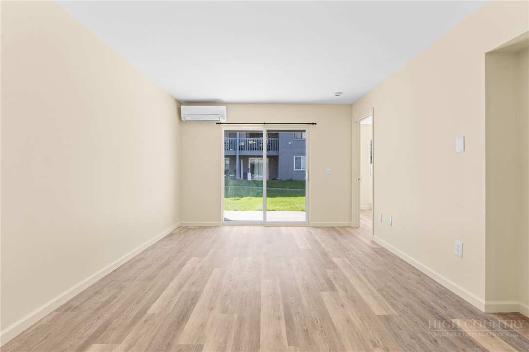 128 Zeb Street, Unit A104 Boone, NC 28607 - Photo 3 of 35 an empty room with wooden floor and windows