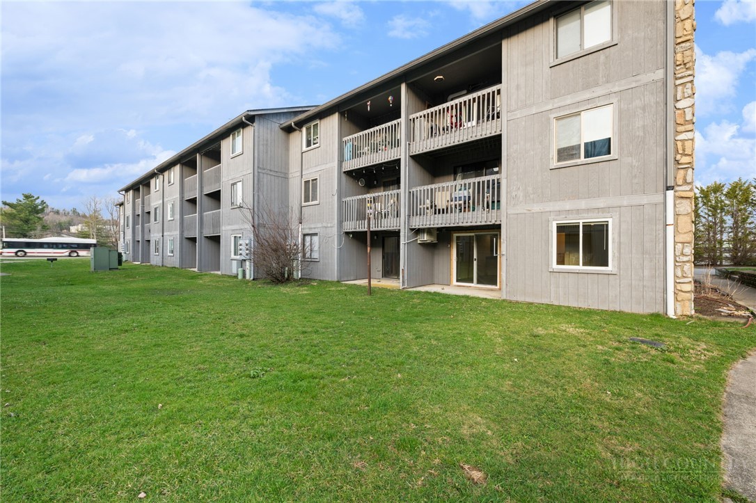 128 Zeb Street, Unit A104 Boone, NC 28607 - Photo 31 of 35 a large building with a yard