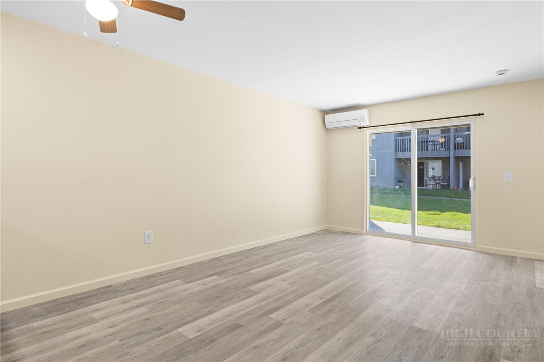 128 Zeb Street, Unit A104 Boone, NC 28607 - Photo 4 of 35 a view of an empty room with wooden floor