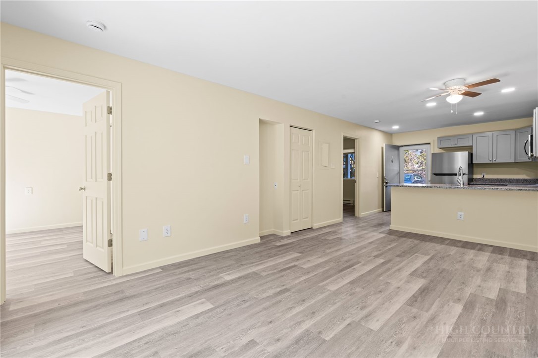 128 Zeb Street, Unit A104 Boone, NC 28607 - Photo 6 of 35 a view of a kitchen with wooden floor and a kitchen