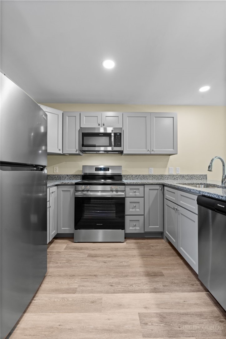 128 Zeb Street, Unit A104 Boone, NC 28607 - Photo 10 of 35 a kitchen with a sink stove and microwave