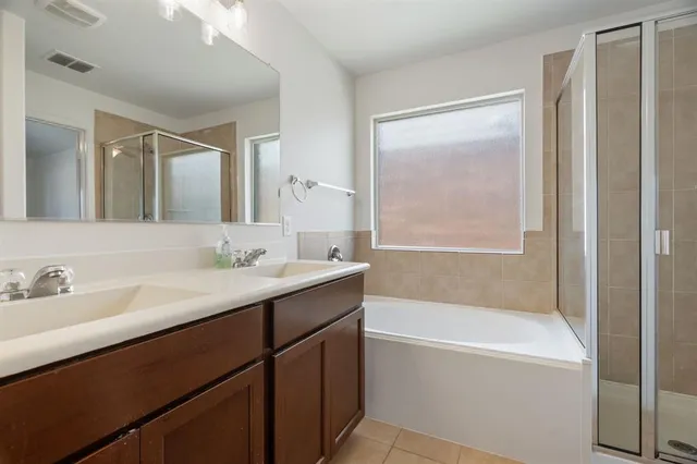 a bathroom with a tub sink and mirror