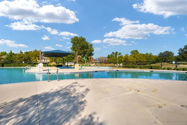 a view of a swimming pool and an outdoor seating