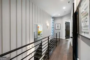 a view of a hallway with wooden floor and staircase
