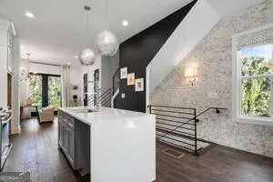 a kitchen with a sink appliances and wooden floor
