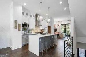 a kitchen with sink cabinets and living room view