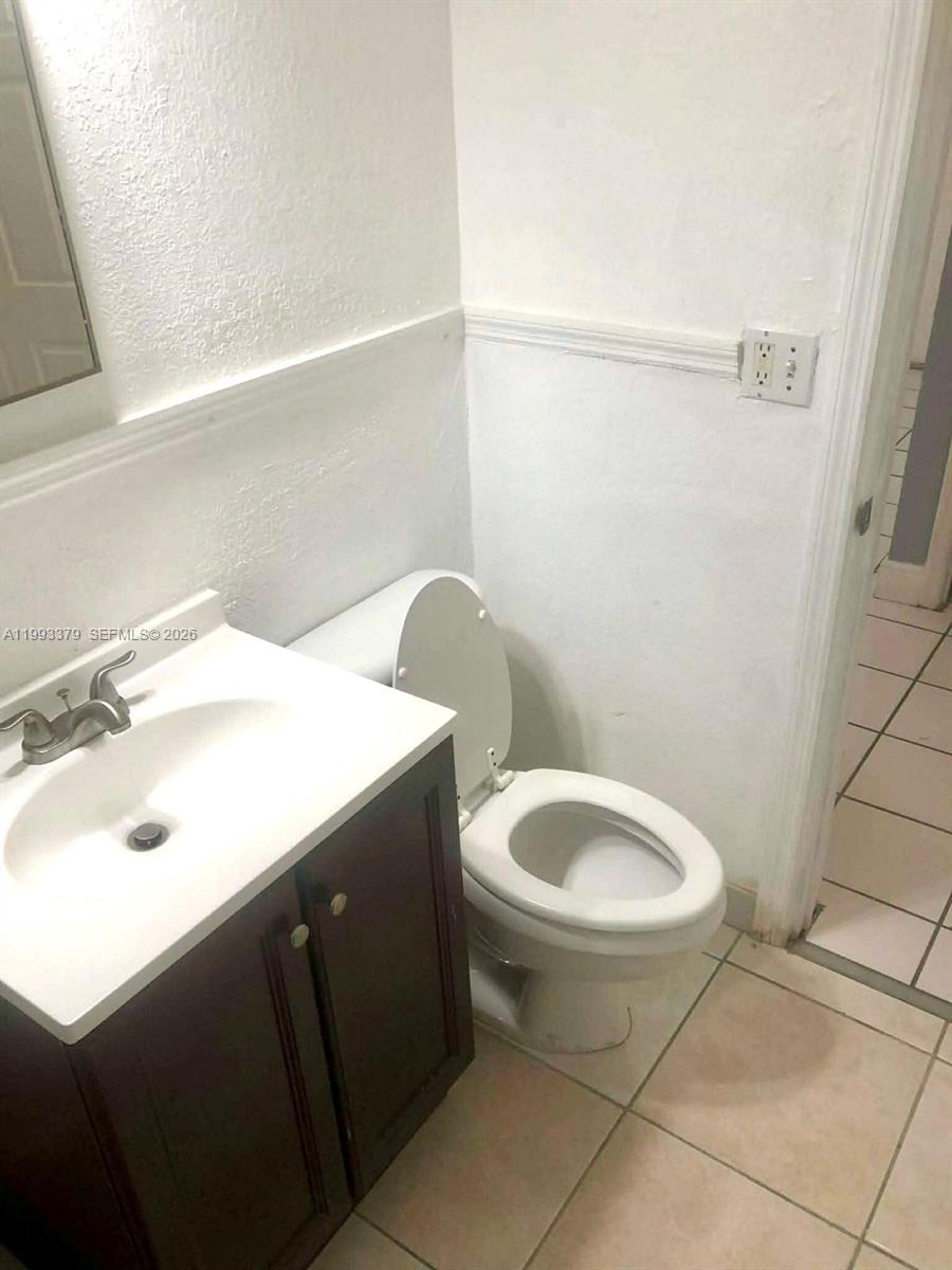 580 Tallulah Road Lake Worth, FL 33462 - Photo 9 of 12 a bathroom with a sink and a toilet