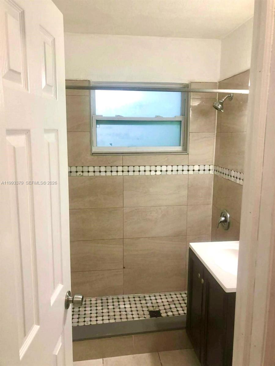 580 Tallulah Road Lake Worth, FL 33462 - Photo 10 of 12 a bathroom with a shower and a sink