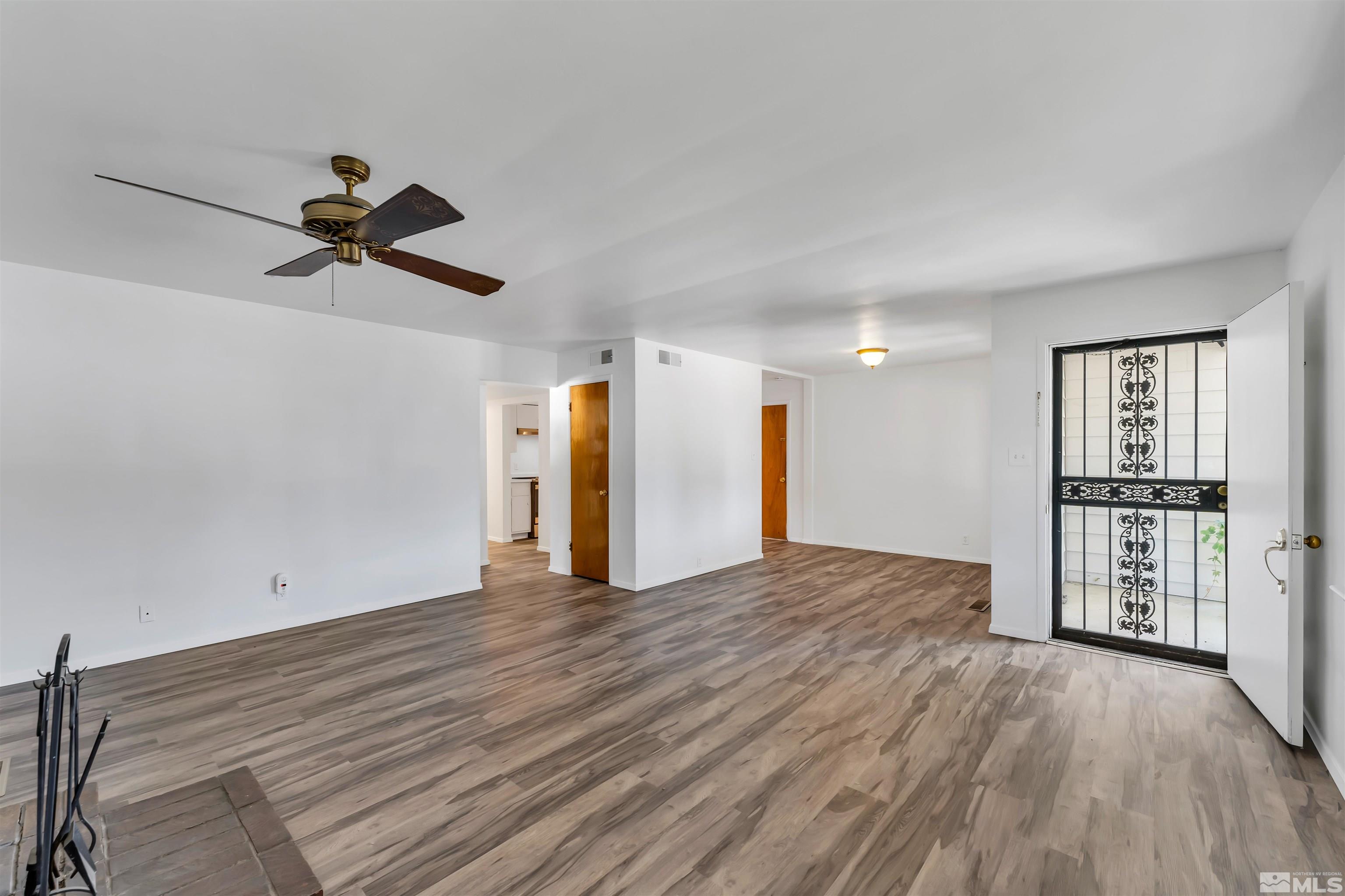 1610 Auburn Way Reno, NV 89502 - Photo 1 of 23 wooden floor in an empty room with a window