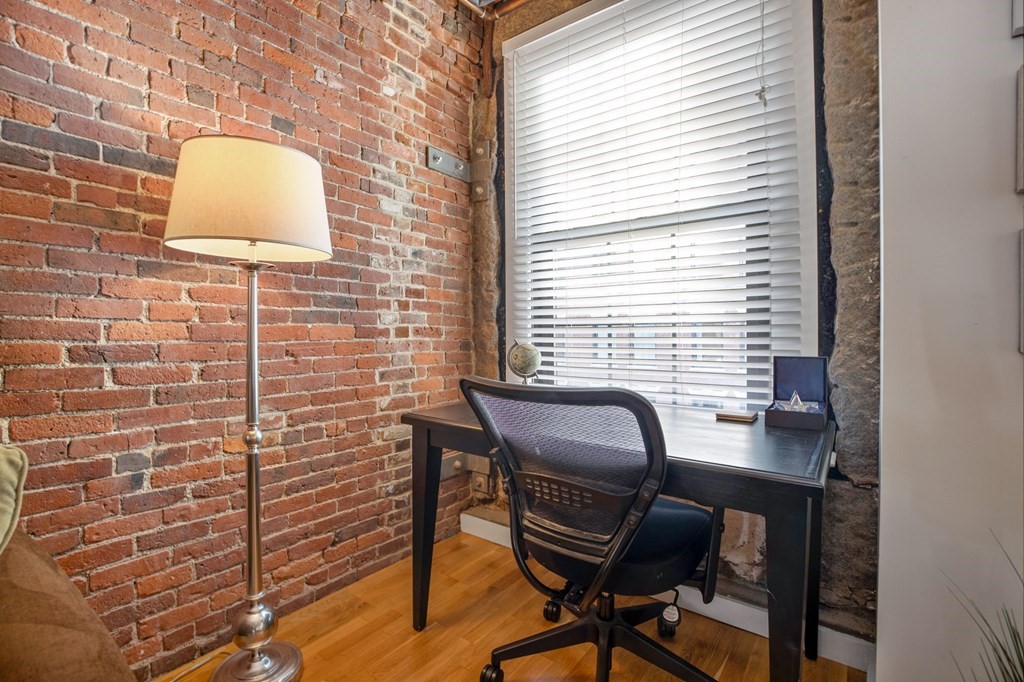101 Broad Street, Unit 5D Boston, MA 02110 - Photo 5 of 13 a workspace with furniture and a window