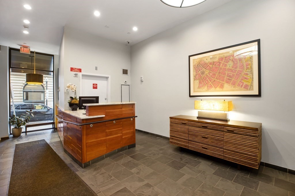 101 Broad Street, Unit 5D Boston, MA 02110 - Photo 9 of 13 a room with a bed and a window