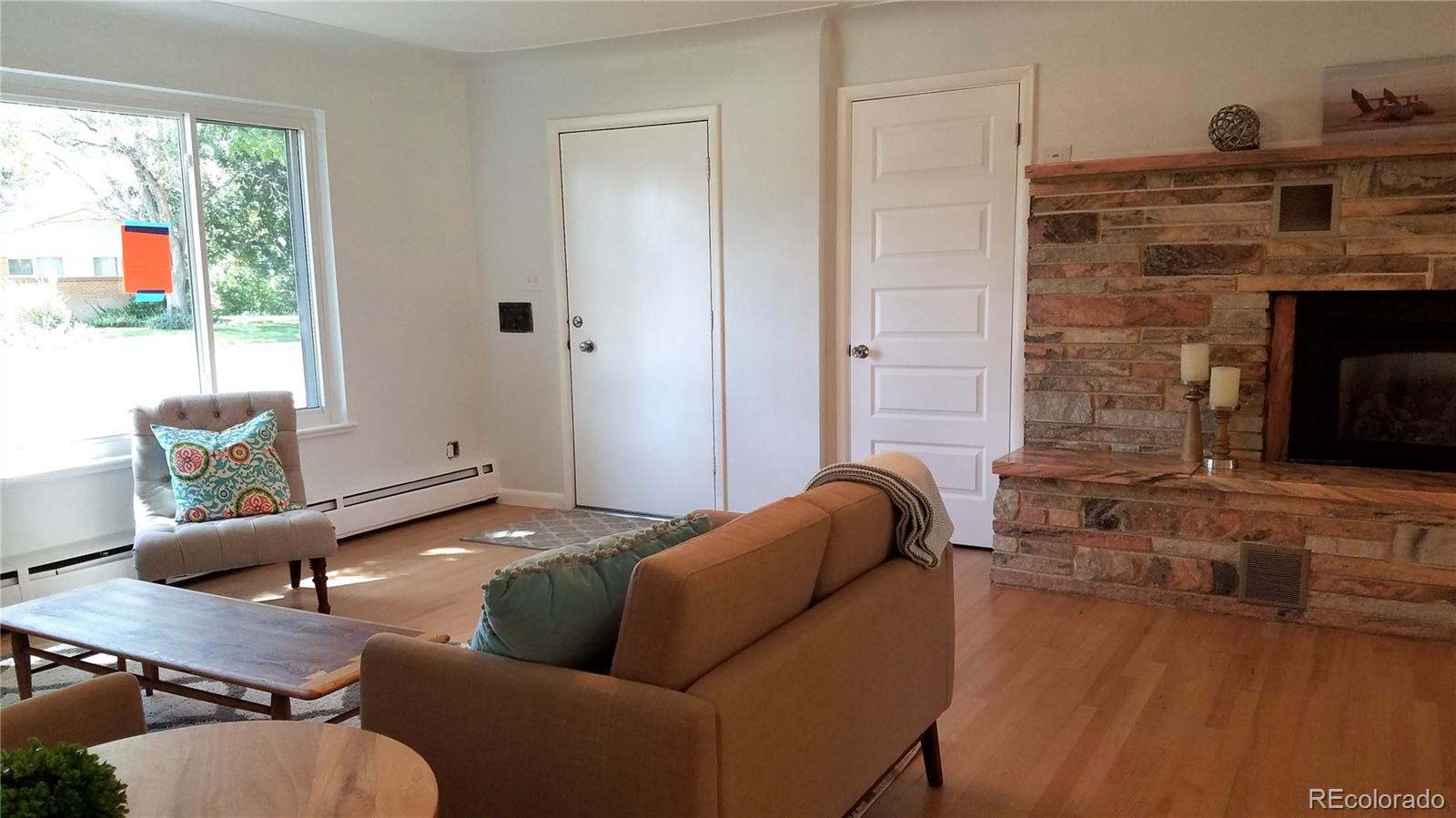 4630 Quay Street Wheat Ridge, CO 80033 - Photo 3 of 36 a living room with furniture and a fireplace