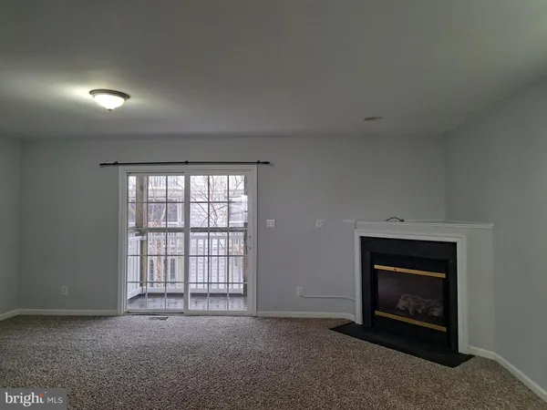 an empty room with a fireplace