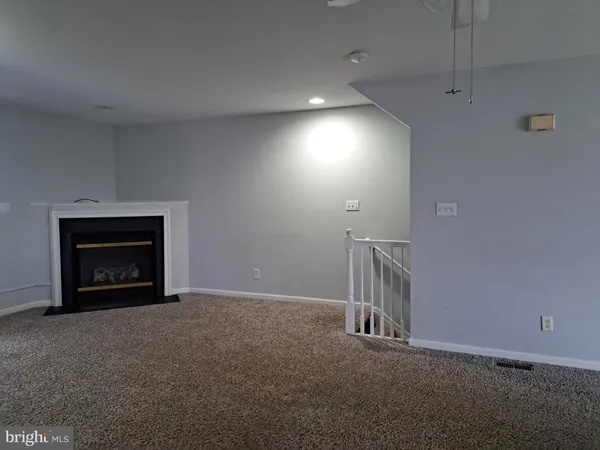 an empty room with a fireplace