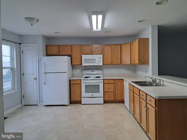 a kitchen with a stove sink and a refrigerator