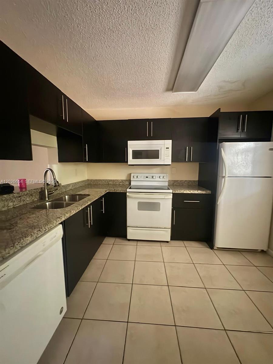 4174 Inverrary Drive, Unit 903 Lauderhill, FL 33319 - Photo 25 of 36 a kitchen with a cabinets counter top space and appliances