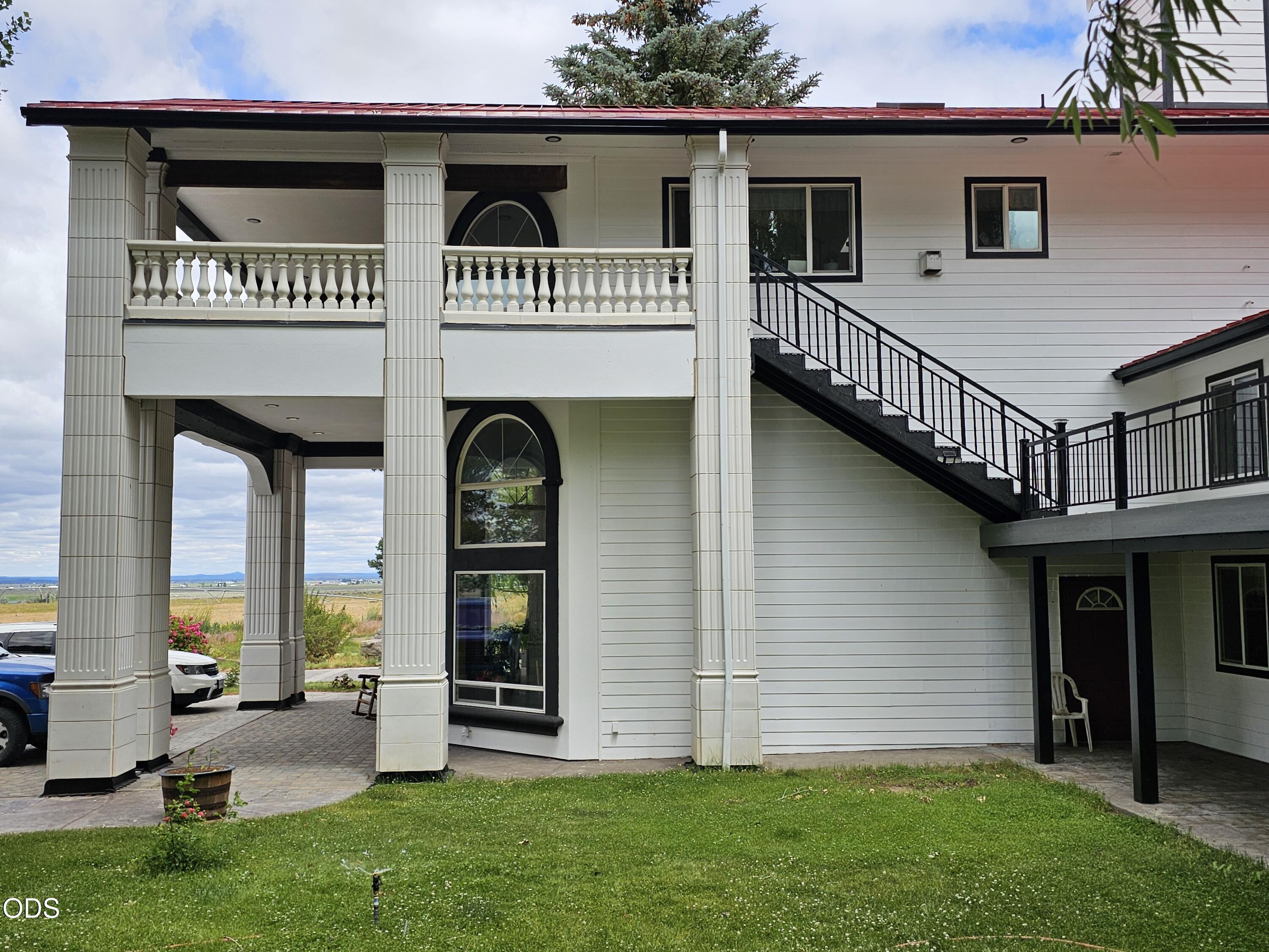 59047 Old Lake Road Christmas Valley, OR 97641 - Photo 62 of 68 a view of a house with many windows and a yard