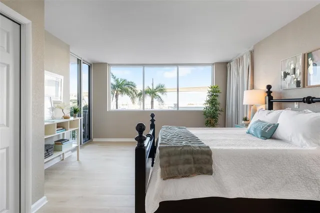 a bedroom with a large bed and a large window