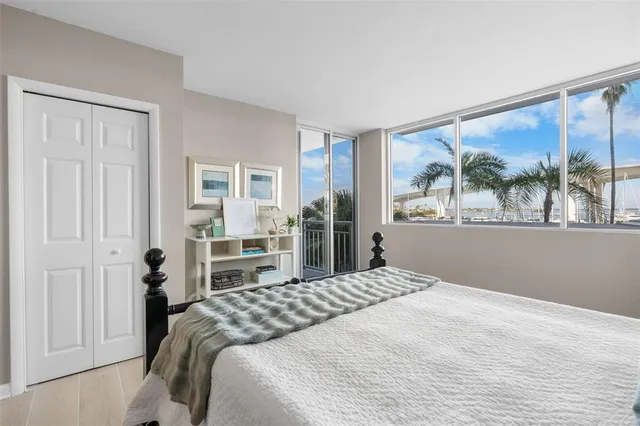 a bedroom with a large bed and a painting on the wall