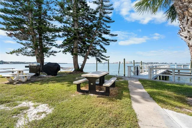 a view of a lake with a sitting area and a swimming pool