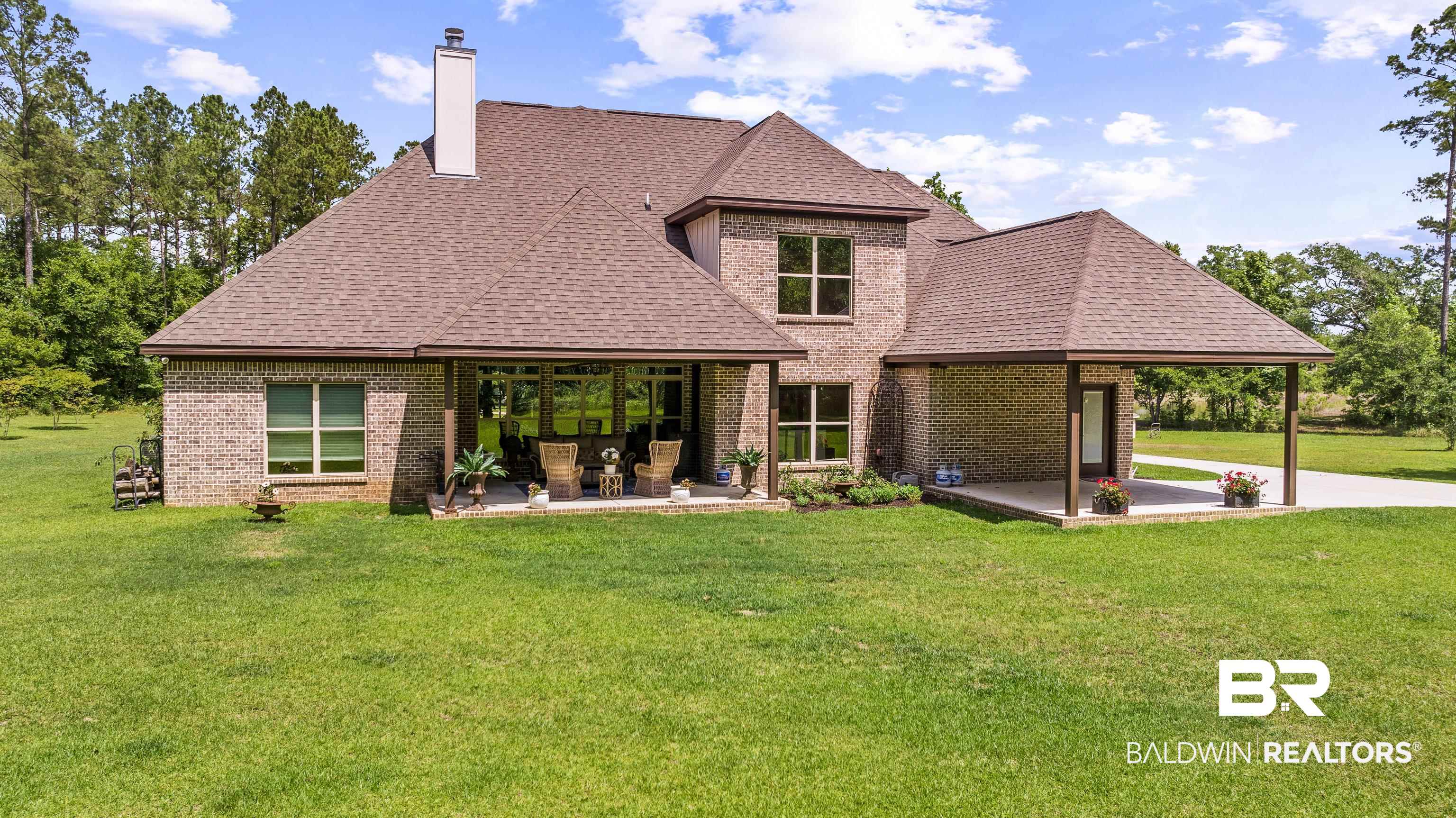 36784 Legacy Way Bay Minette, AL 36507 - Photo 42 of 57 Back of house featuring a patio area, brick siding, a chimney, and a lawn