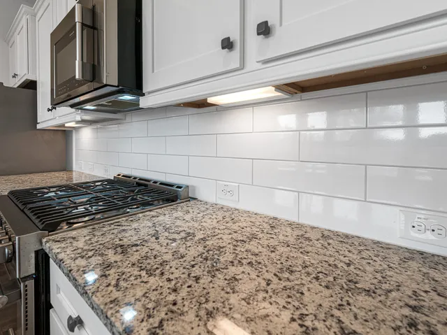 a stove top oven sitting inside of a kitchen