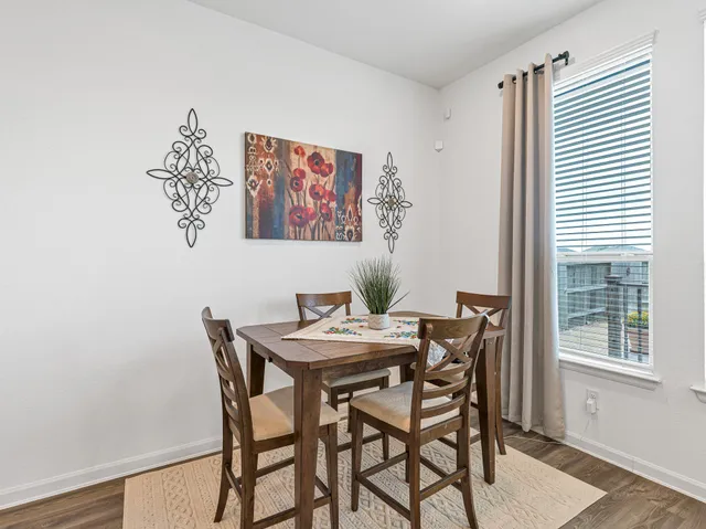 a view of a dining room with furniture and a window